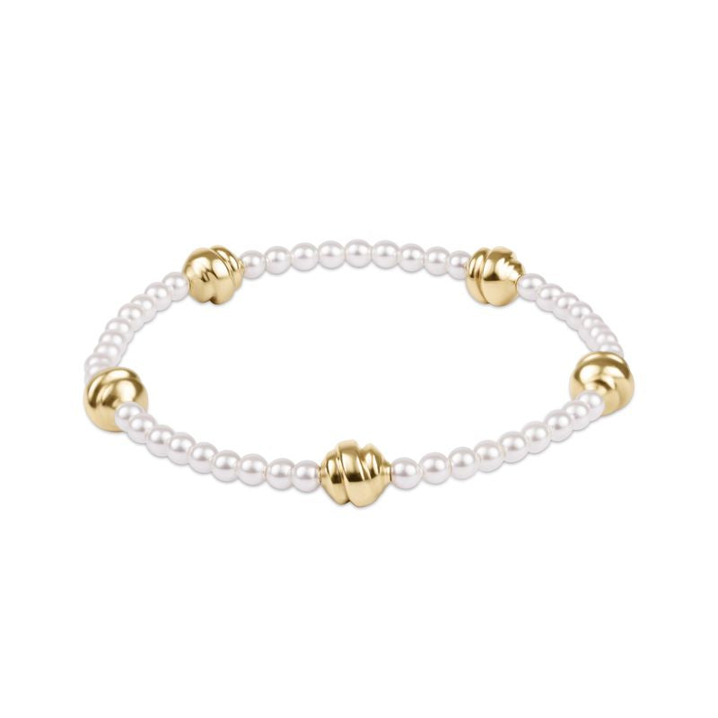Pearl bracelet with gold beads on a white background