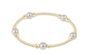 Gold bracelet with pearls on a white background