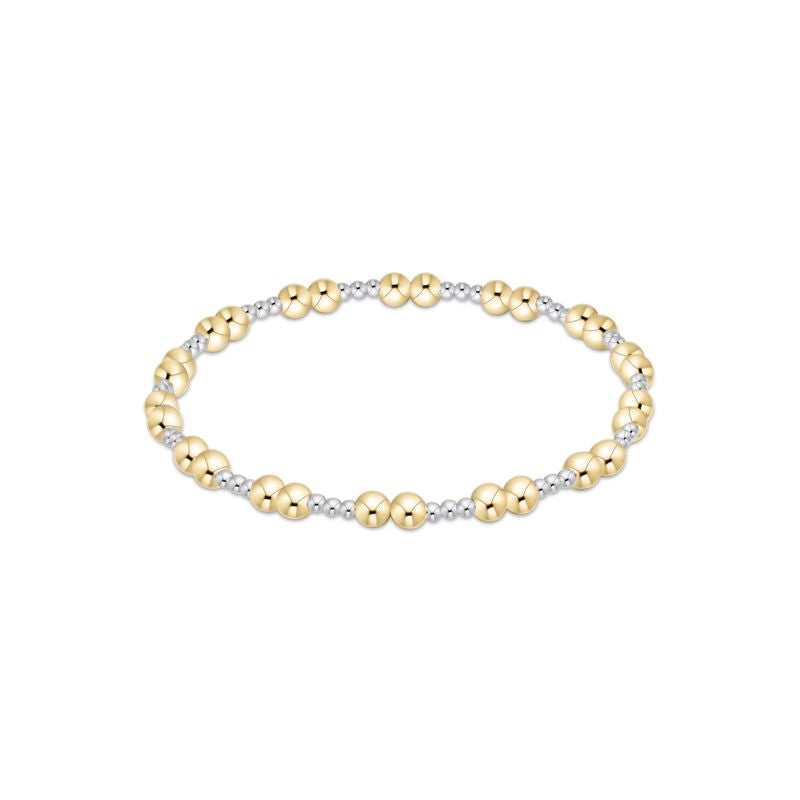 Gold and silver beaded bracelet on a white background