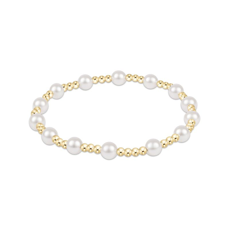 Pearl and gold beaded bracelet on a white background