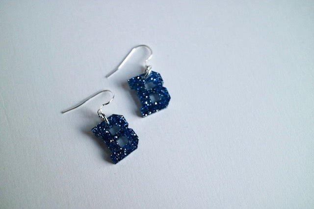 Acrylic Bedford Blue Glitter “B” Earrings - Juli's Wearable Art